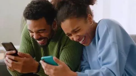 AI Video from prompt: They look at their phones and laugh until they c