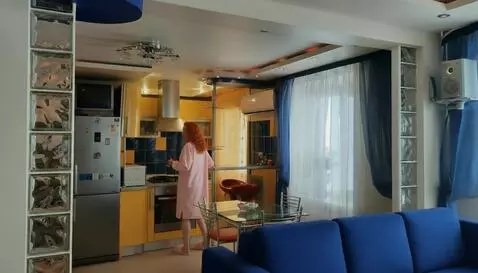 AI Video from prompt: The girl cooks, turns the food in the pan with a