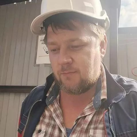 AI Video from prompt: A man walking through a construction site, weari