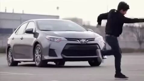 AI Video from prompt: A kid is dancing near a Lezginka car Toyota coro
