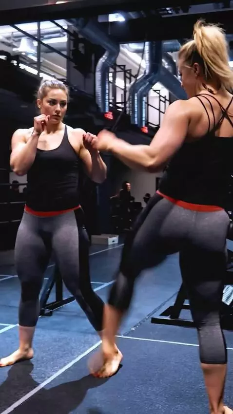 AI Video from prompt: kickboxing girl fights her double in the ring