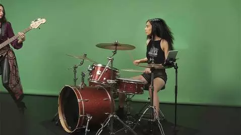 AI Video from prompt: the camera closes in to the right of the drummer