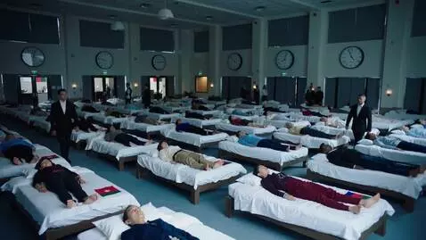 AI Video from prompt: A massive indoor hall filled with rows of beds. 
