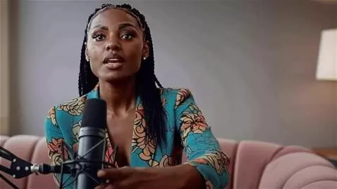 AI Video from prompt: The woman using one hand to pull the boom arm mi