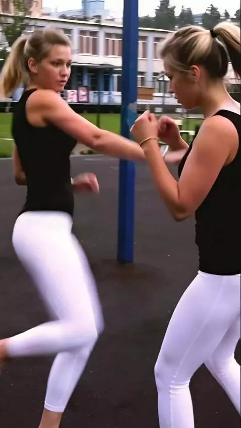 AI Video from prompt: A kickboxing girl fight her double  in the ring 
