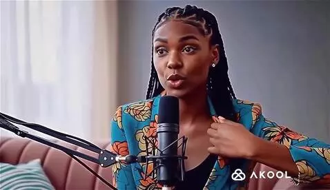 AI Video from prompt: the woman briefly brushing her lapel or adjustin