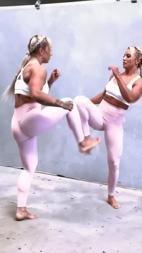 AI Video from prompt: A kickboxing girl  fights her double in the  rin