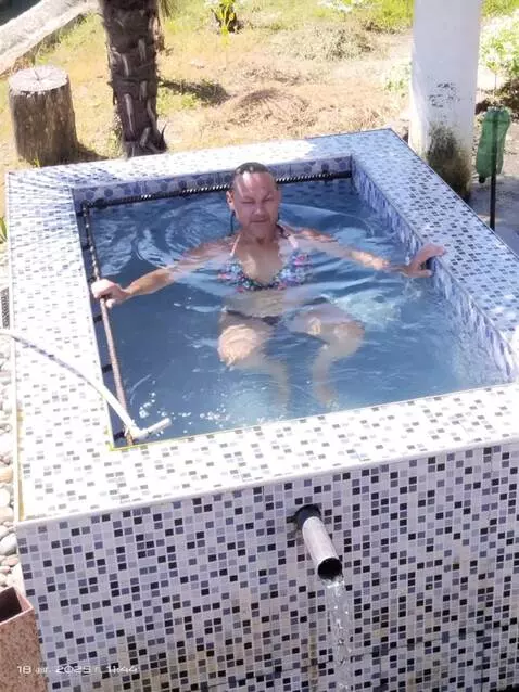 AI Video from prompt: The girl gets up and comes out of the water