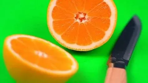 AI Video from prompt: A lemon is cut in half, with an orange filling i
