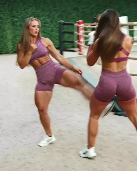 AI Video from prompt: A kickboxing girl fights her double in the ring 