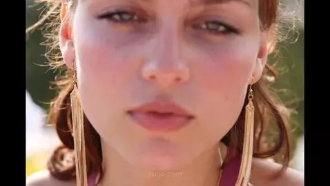 AI Video from prompt: A shy smile plays on the woman's lips as she fas