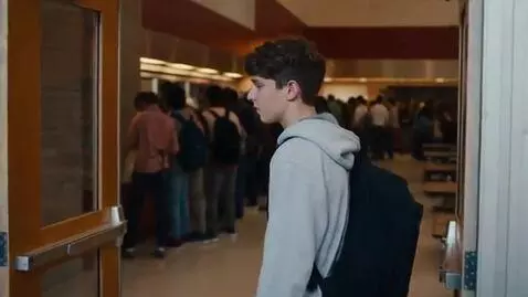 AI Video from prompt: Interior of a modern high school. The teenage bo