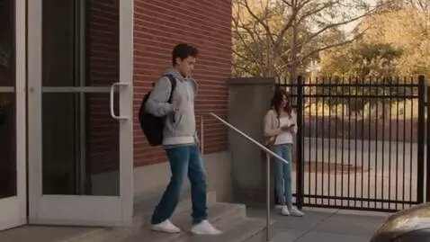 AI Video from prompt: Exterior of the school, soft afternoon light. Th