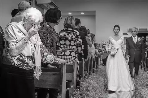 AI Video from prompt: An elderly woman stands at the altar waiting for