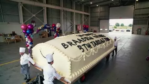 AI Video from prompt: Drone footage: A group of chefs rolls out of a h