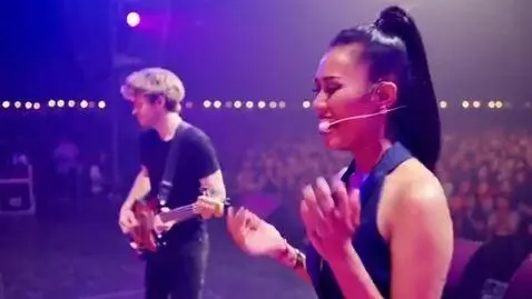 AI Video from prompt: A 22-year-old Russian man plays bass guitar, and