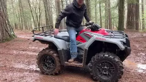 AI Video from prompt: a honda forman rubicon that is gray and red in a