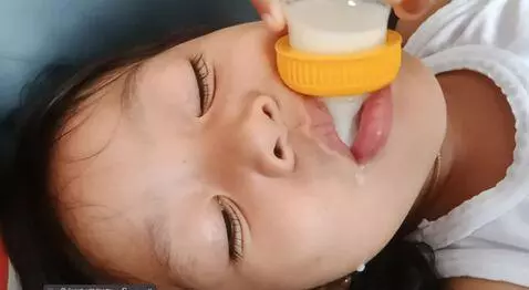 AI Video from prompt: make her drink milk from the bottle