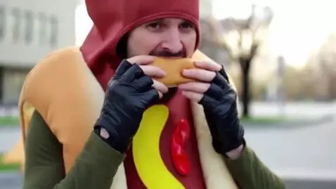 AI Video from prompt: a hotdog guy eats a hot dog with they black glov