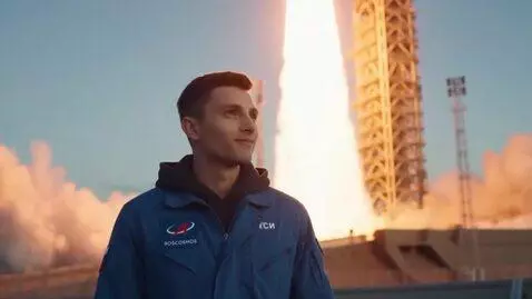 AI Video from prompt: A young Roscosmos specialist stands near a rocke
