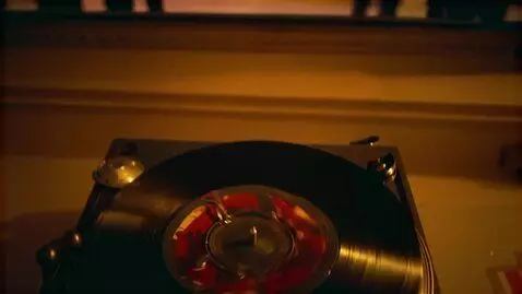 AI Video from prompt: A vinyl record spins in an analog world, recalli