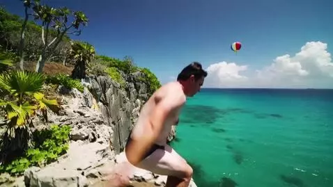AI Video from prompt: cliff diving into green ocean under sun with bal