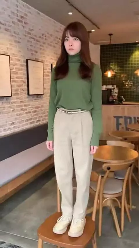 AI Video from prompt: A girl stands motionless on a chair in a cafe, m