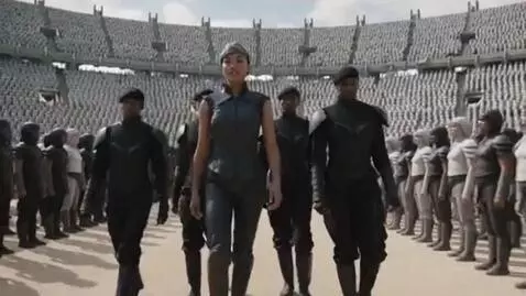 AI Video from prompt: A huge Burmese woman, 23, walks around the stadi