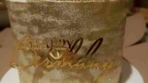 AI Video from prompt: A luxurious birthday cake crowned with a glitter