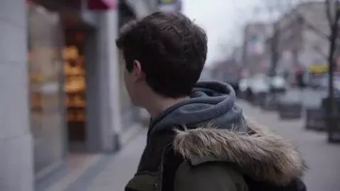 AI Video from prompt: A Serbian boy in the city is looking for a baker