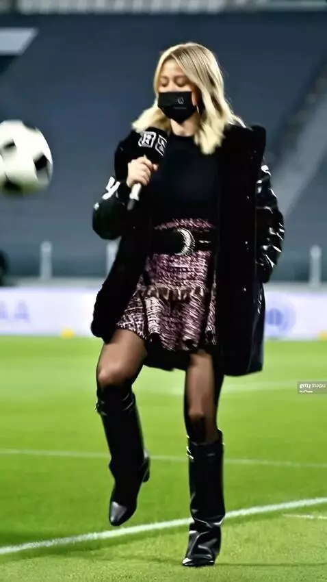 AI Video from prompt: The a girl football player in a skirt kicks the 