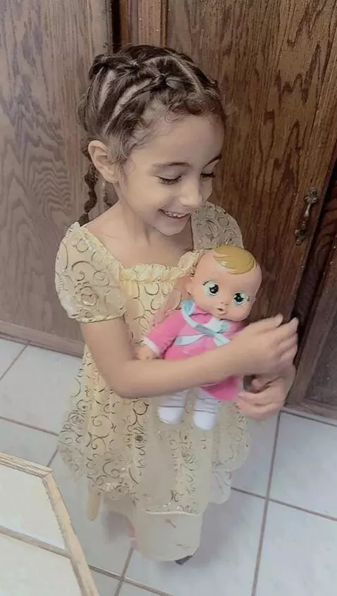 AI Video from prompt: Girl drops her doll and poses cutely