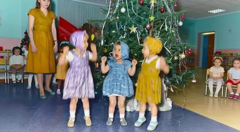 AI Video from prompt: Three little girls are dancing near the Christma