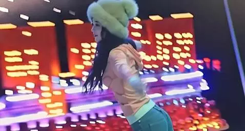 AI Video from prompt: A woman slowly spins around herself. As she keep