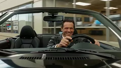 AI Video from prompt: A scene from inside a convertible. The driver dr