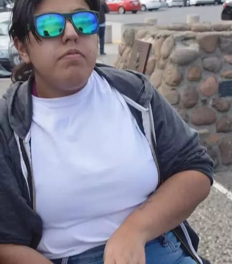 AI Video from prompt: Make the camera show her outfit which includes h