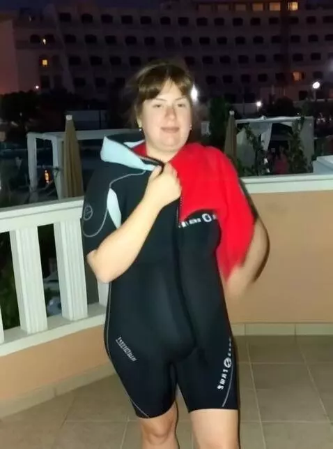 AI Video from prompt: The girl is taking off the suit