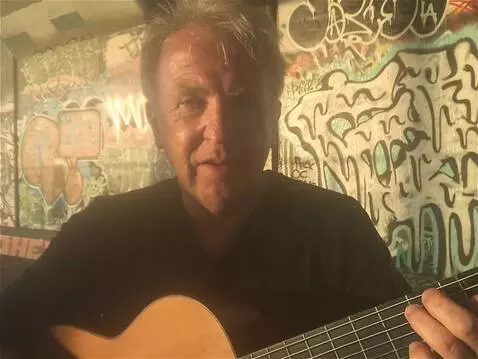 AI Video from prompt: the camera pans down to reveal the musician play