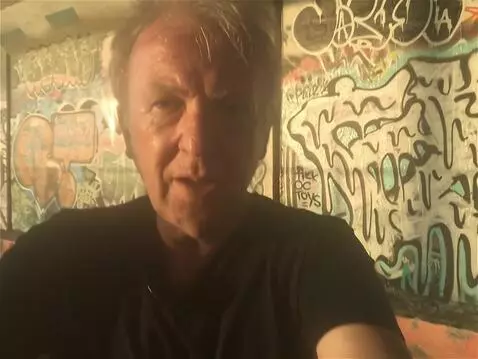 AI Video from prompt: he is not singing,  the camera pans down to reve