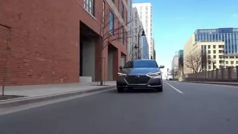 AI Video from prompt: Car goes along city, car moves to camera, sunny 