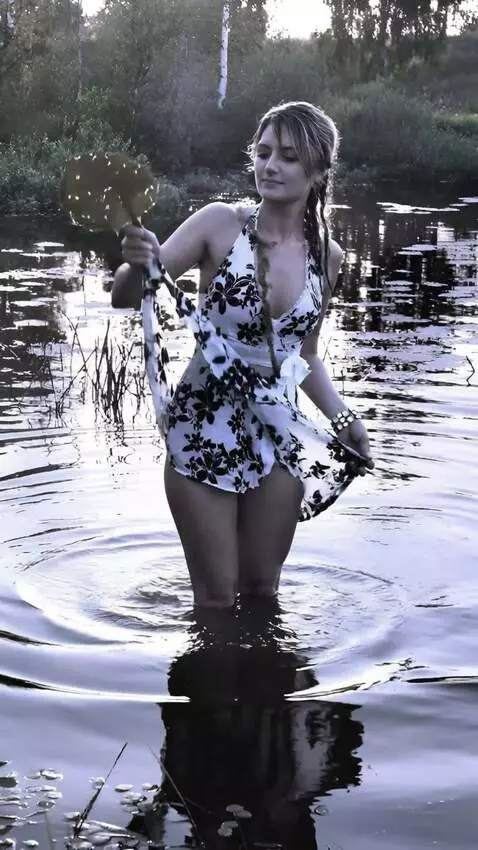 AI Video from prompt: a girl pulls a huge moray eel out of the water