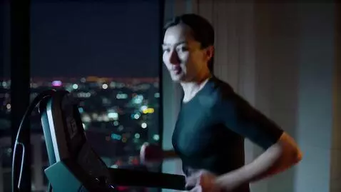 AI Video from prompt: Running at night on treadmill in luxurious penth