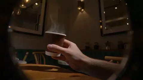 AI Video from prompt: Cinematic, extreme close-up of a hand holding a 