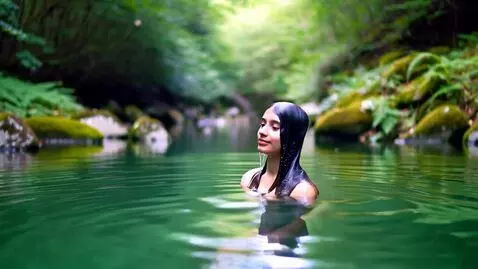 AI Video from prompt: The young woman emerges from a forest lake.