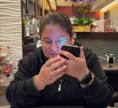 AI Video from prompt: She puts her phone down quick and rolls up both 