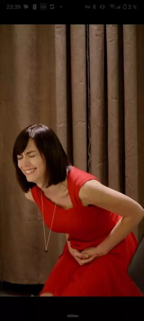 AI Video from prompt: The girl's stomach twisted violently. She's curl