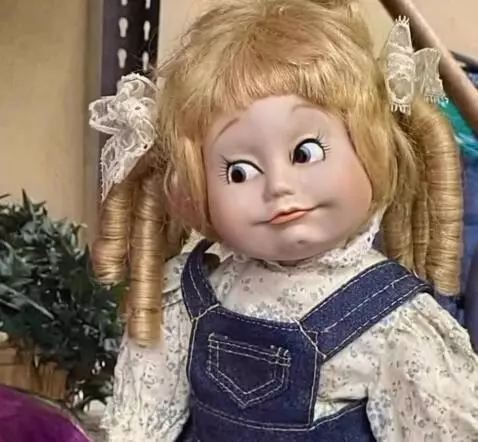 AI Video from prompt: A vintage porcelain doll with blonde curly hair 