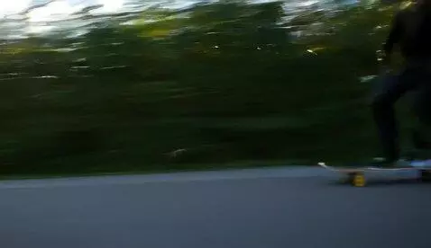 AI Video from prompt: Cyborg Skateboarder in motion, blur, light trail