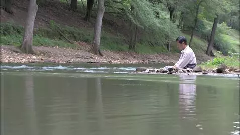 AI Video from prompt: man siting near river