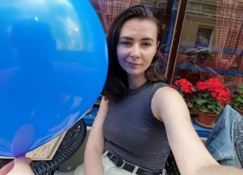 AI Video from prompt: In the video, the girl holds a blue balloon and 
